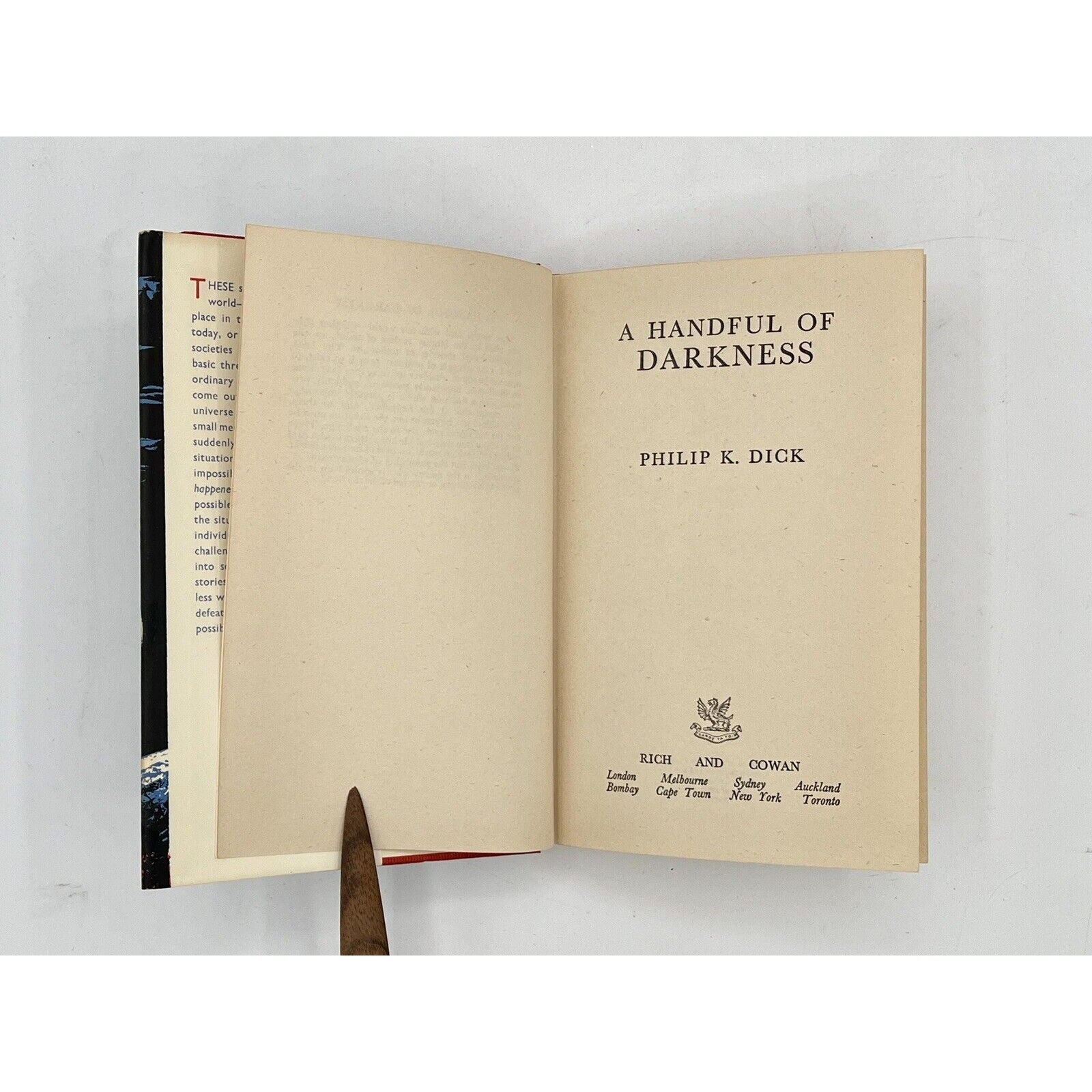 Open book titled 'A Handful of Darkness' by Philip K. Dick