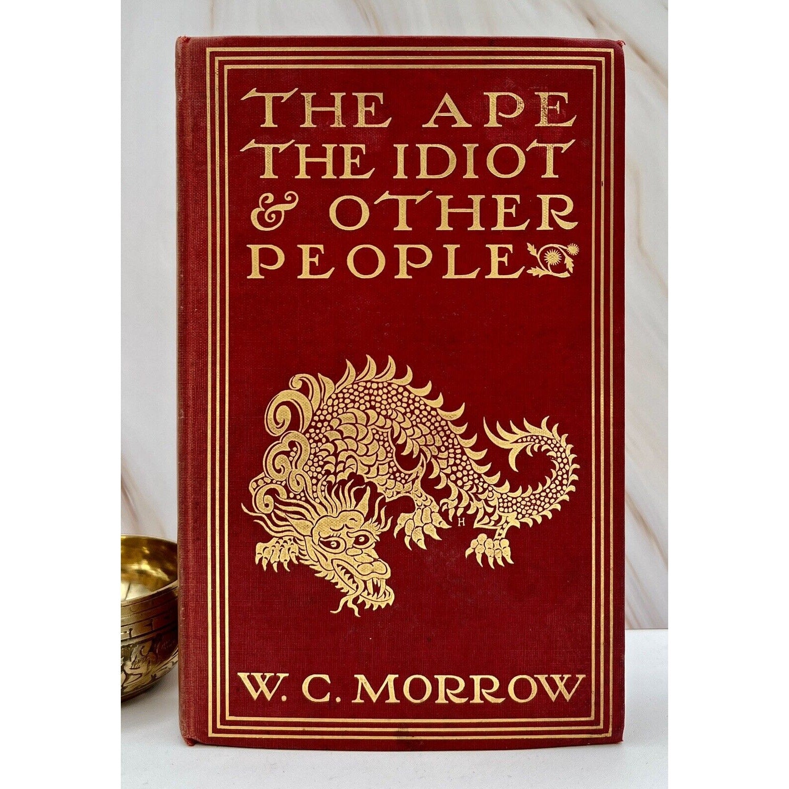 First edition W. C. Morrow: The Ape The Idiot & Other People, 1897 red hardcover with gold dragon.