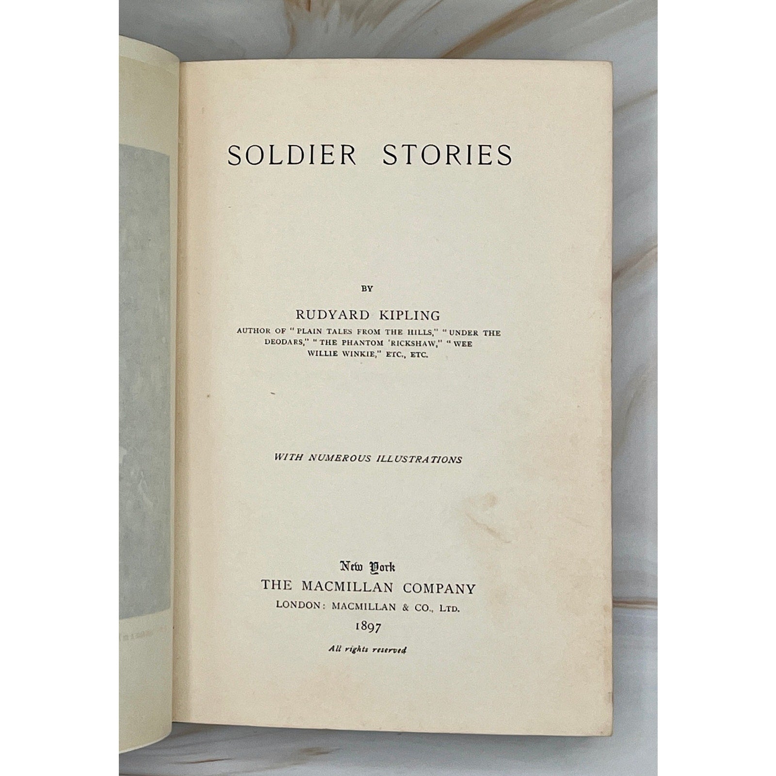 Antique 1897 Kipling Soldier Stories hardcover with gilt-stamped cover depicting soldiers and exotic wildlife.